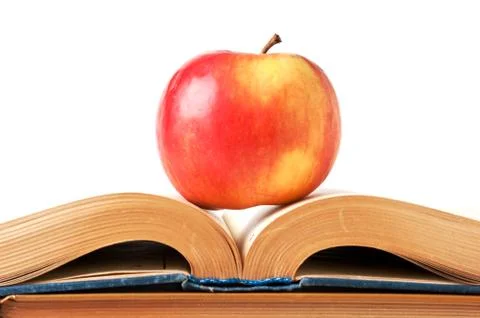 Apple and an open book Stock Photos