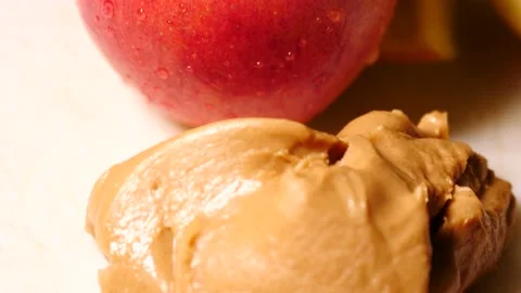 Apple and peanut butter close up slowly tilting down being eaten Stock Footage 234589524