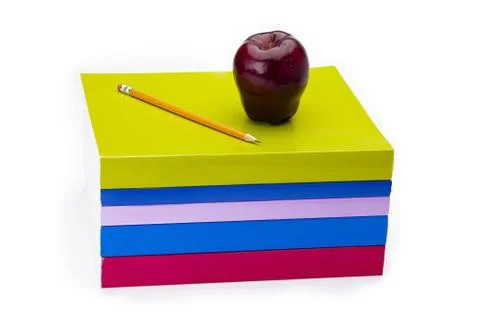 Apple and pencil sitting on stack of books Stock Photos