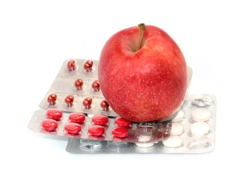 Apple and pill Stock Photos