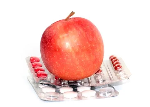 Apple and pill Stock Photos