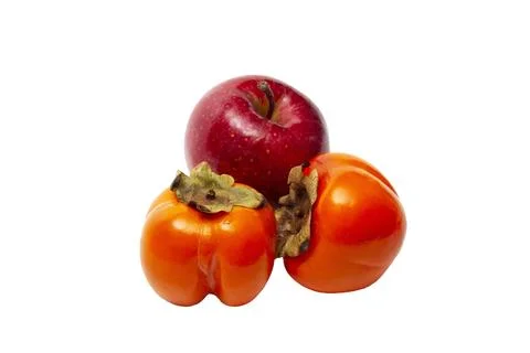 An apple and two persimmons on a transparent background. Stock Photos
