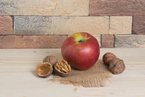 Apple and walnuts in a rustic interior Stock Photos
