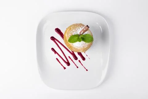 Apple baked with mint leaf and chocolate sauce on white plate background Stock Photos