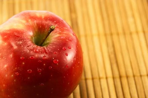 Apple on a bamboo mat Stock Photos