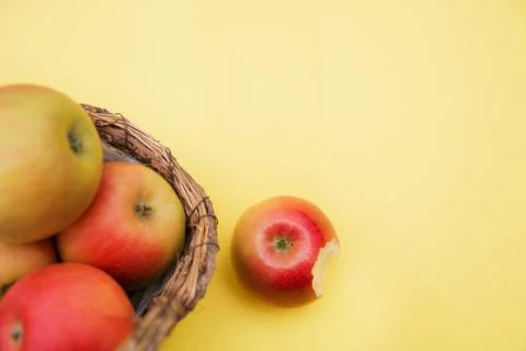 Apple in basket on yellow background composition and concept of autumn Stock Photos