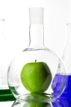 Apple in beaker Stock Photos