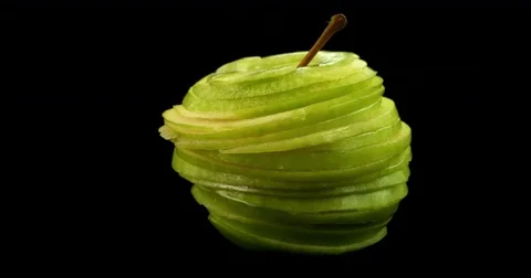 Apple being made up by slices put together. Fresh and modern concept on healthy Stock Footage 75630383