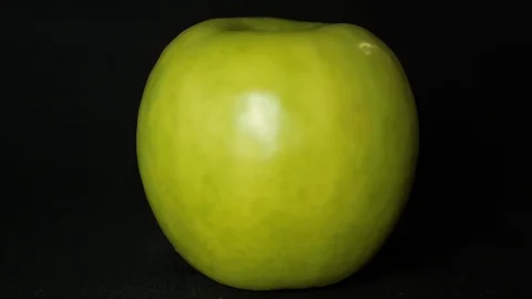 Apple on black background Stock Footage 101664434
