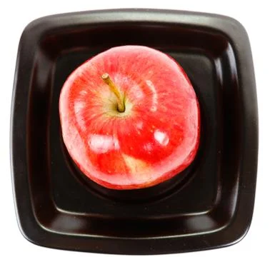 Apple on a black plate Foto stock