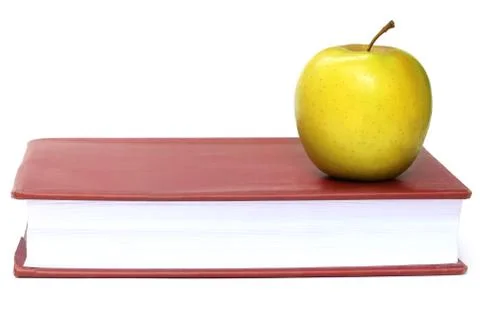 Apple on a book Stock Photos