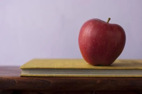 Apple with book Stock Photos