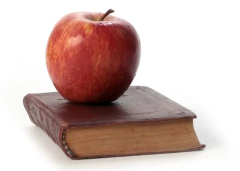 Apple on an book Stock Photos