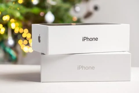 Apple boxes with red bow against Christmas tree Stock Photos