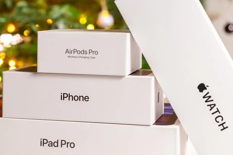 Apple boxes with red bow under Christmas tree Stock Photos
