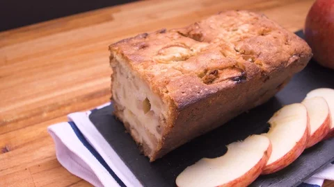 Apple Bread Cake Pan Close Up On Black Slate With Sliced Apples Over Wood 6 Video stock 128092371