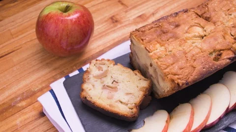 Apple Bread Cake Pan Close Up On Black Slate With Sliced Apples Over Wood 4 Video stock 128092479
