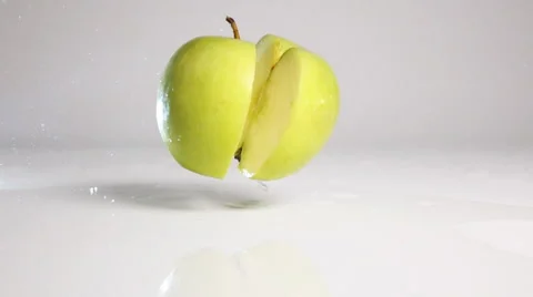 Apple break on two halves on white surface Video stock 63074311