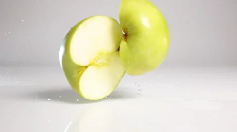 Apple break on two halves on white surface Video stock 63075308