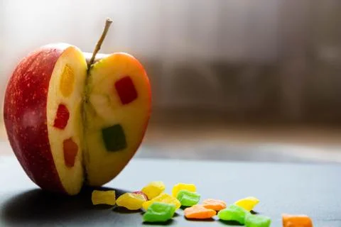 The apple with a candied fruit inside. Close up view on the side of Incised a Stock Photos