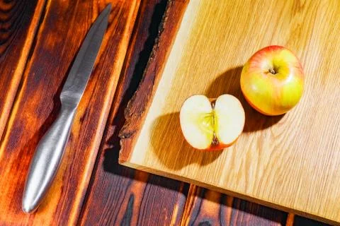 Apple on the chopping Board as background Photos