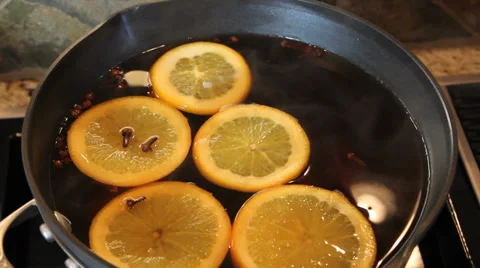 Apple Cider with Cloves Orange Slices and Cinnamon Sticks Cooking 1080p Stock Footage 33194355