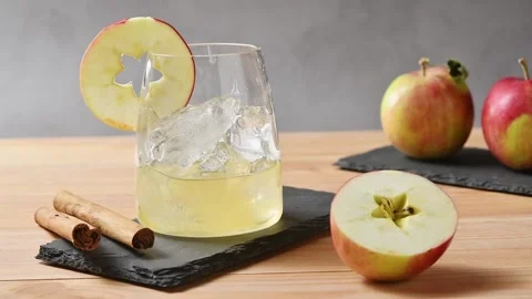 Apple cider, tonic and cold brew coffee pour over ice before glass straw stirs Stock Footage 345558229