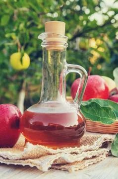 Apple cider vinegar in a bottle. Selective focus. Stock Photos