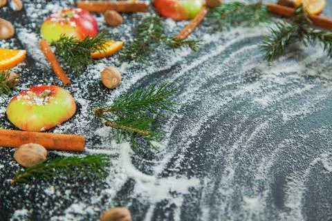 Apple cinamon nutmeg orange snow green fir branches new year Photos