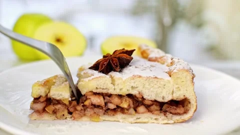 Apple cinnamon pai cake sprinkled powdered sugar break off using a fork. Stock Footage 236476542
