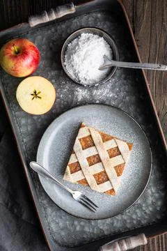 Apple cinnamon pie slices with lattice top sprinkled with powdered sugar Stock Photos