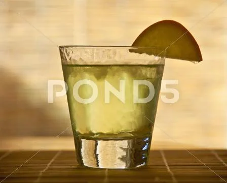 Apple Cocktail garnished with an apple slice Stock Photos