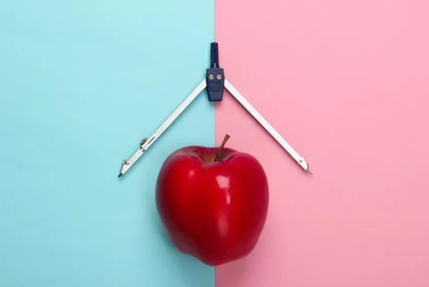 Apple, compass on pink blue background. Back to school. Education concept. To Stockfoto's
