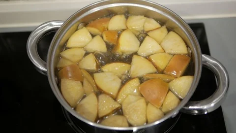 Apple compote is cooked in a saucepan Stock Footage 98134570