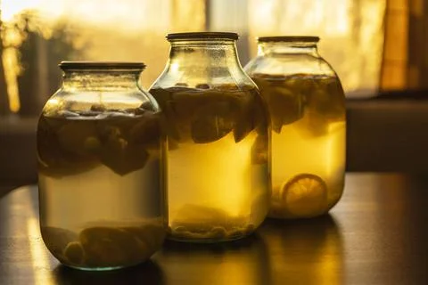 Apple compote in glass jars on the kitchen table, soft evening light Stock Photos
