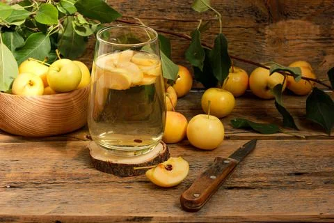 Apple compote in a glass on a wooden table with a background of fresh yellow Stock Photos