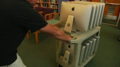 Apple Computers being brought into school Stock Footage 11520639