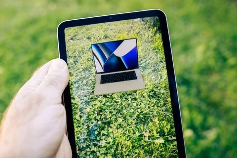 Apple Computers Ipad Mini tablet computer looking in the garden at the Augmented Stock Photos