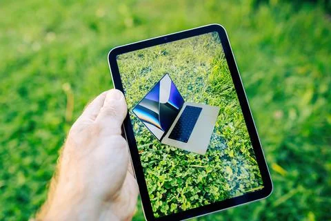 Apple Computers Ipad Mini tablet computer looking in the garden at the Augmented Stock Photos