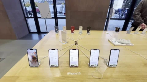 Apple Computers iPhone 13 five smartphones inside Apple Store on the wooden Stock Footage