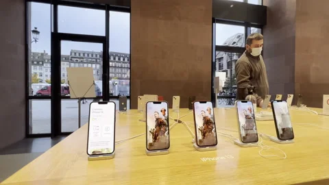 Apple Computers iphone 13 five smartphones inside Apple Store - customer wearing Stock Footage 167290845
