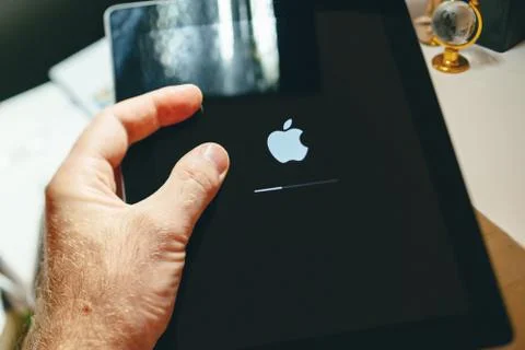Apple Computers logotype logo loading bar holding tablet 写真素材