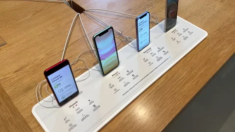 Apple Computers Store interior with multiple iPhones 11, 12 mini , 12 and SE Stock Footage 202171175