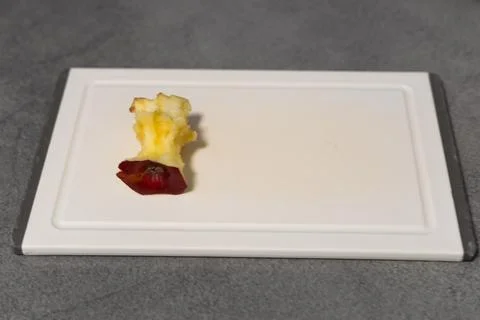 Apple core on a board Stock Photos
