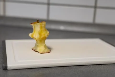 Apple core on a board Stock Photos