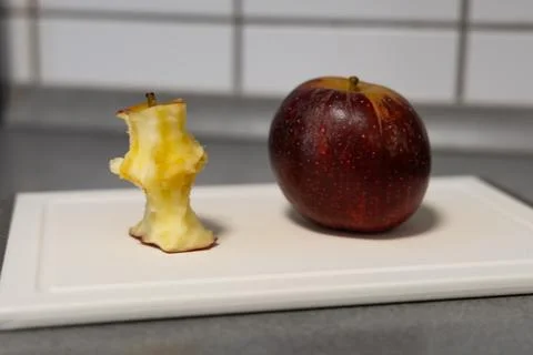 Apple core on a board Stock Photos