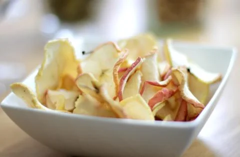 Apple crisps on a table Stock Photos