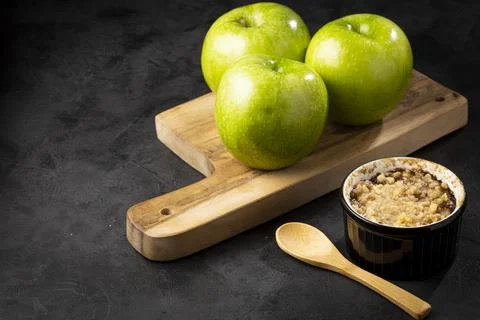 Apple crumble in ramekin on the table. Stock Photos