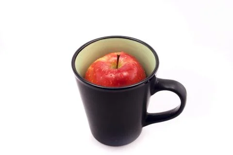 Apple in a cup isolated on white Stock Photos