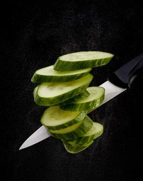 An apple cut with a knife. the background is dark Stock Photos